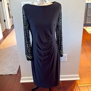 Marina black midi dress with rhinestones on sleeves .